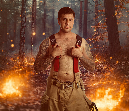 MALE IN WOODS WITH FIRE