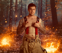 MALE IN WOODS WITH FIRE
